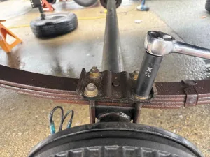 3. Remove the nuts from the U-bolts that attach the axle to the spring.