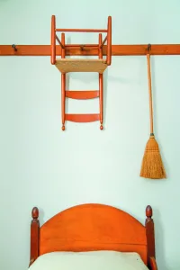 Wall pegs keep items orderly in a Shaker sleeping quarter. 