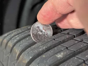 Placing a quarter between the treads is a good way to check whether a tire has enough tread depth. 
